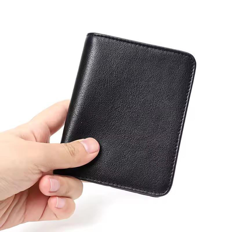 Hand holding a black leather wallet against a white background